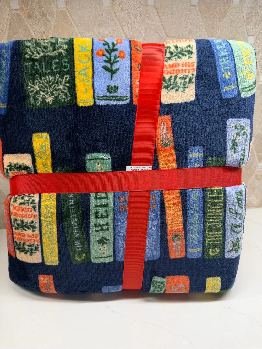 Rifle Paper Co. Navy Fleece Throw with Colorful Book Spine Print